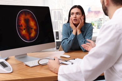 Young woman having appointment with neurologist in clinic