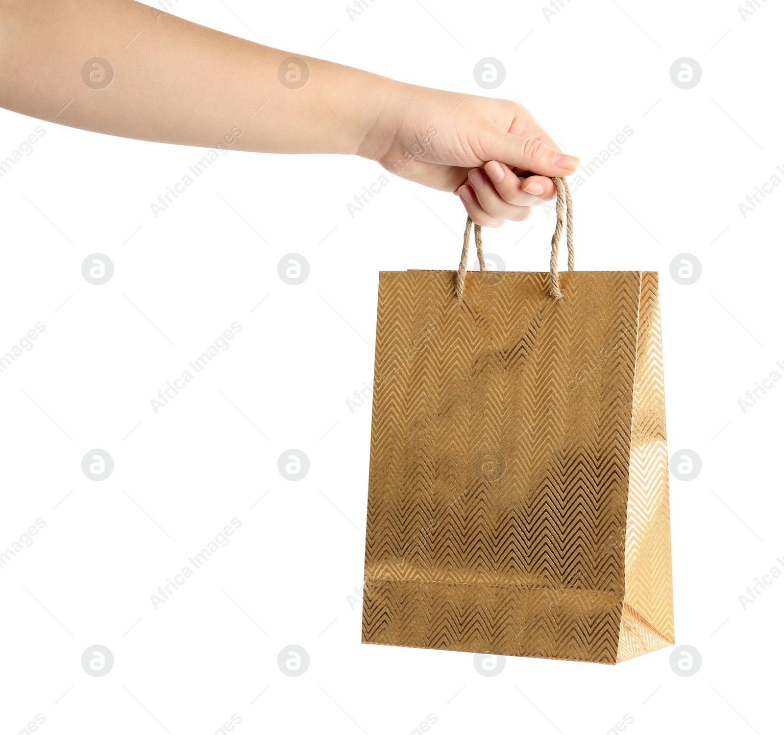 Photo of Woman holding golden paper shopping bag on white background, closeup. Space for design