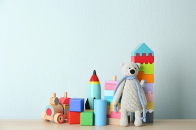 Photo of Set of different toys on wooden table. Space for text