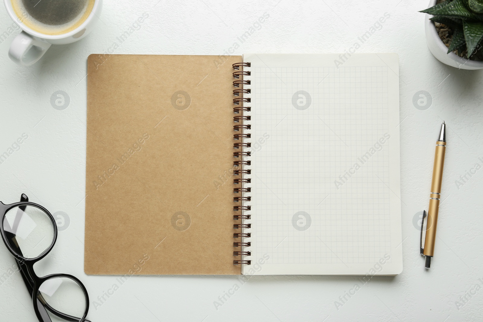 Photo of Flat lay composition with open notebook on white table. Space for text