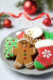 Tasty homemade Christmas cookies on light grey table