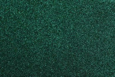 Photo of Shiny dark green glitter as background, closeup