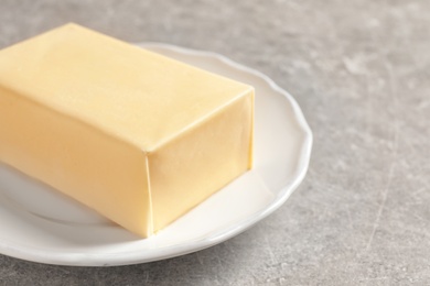 Photo of Plate with fresh butter on table, closeup