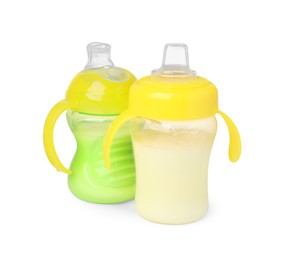 Photo of Feeding bottles with milk on white background
