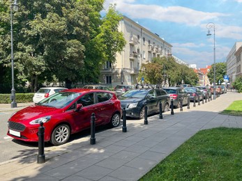 Different modern cars parked on city street