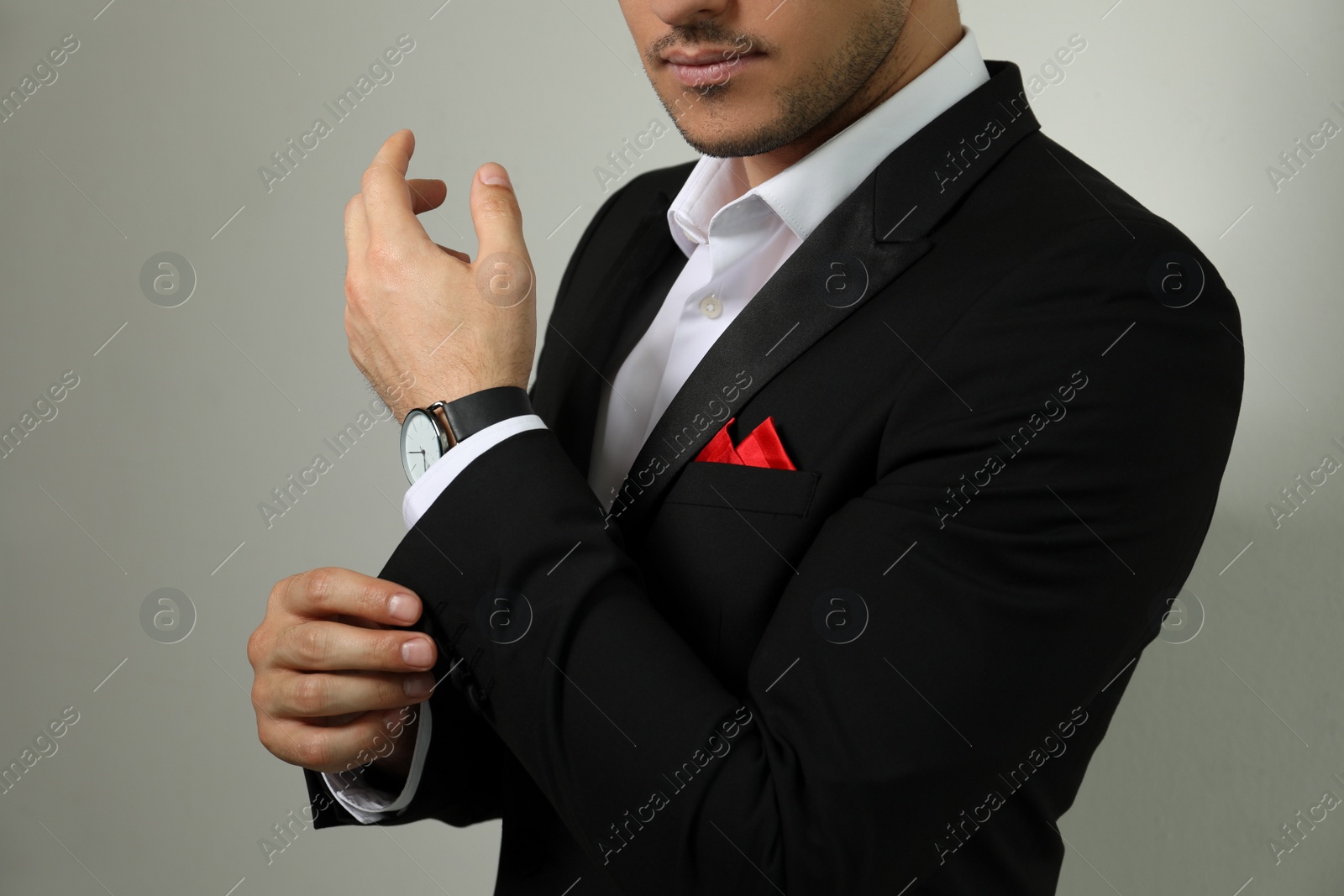 Photo of Man with handkerchief in breast pocket of his suit on light background, closeup