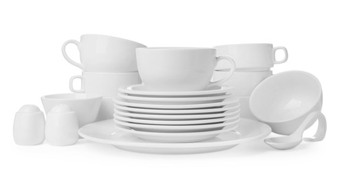 Photo of Set of clean dishware isolated on white