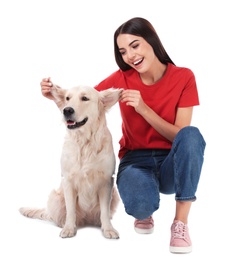 Young woman and her Golden Retriever dog on white background