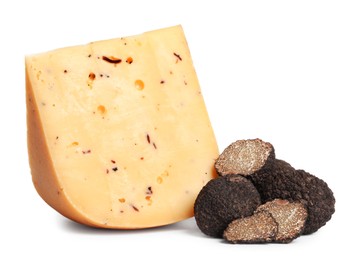 Photo of Piece of delicious cheese with fresh black truffles on white background
