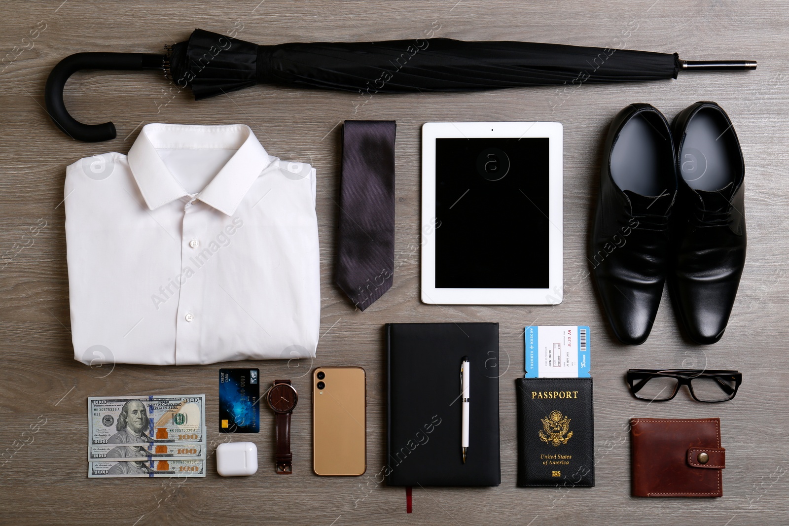 Photo of Business trip stuff on wooden surface, flat lay