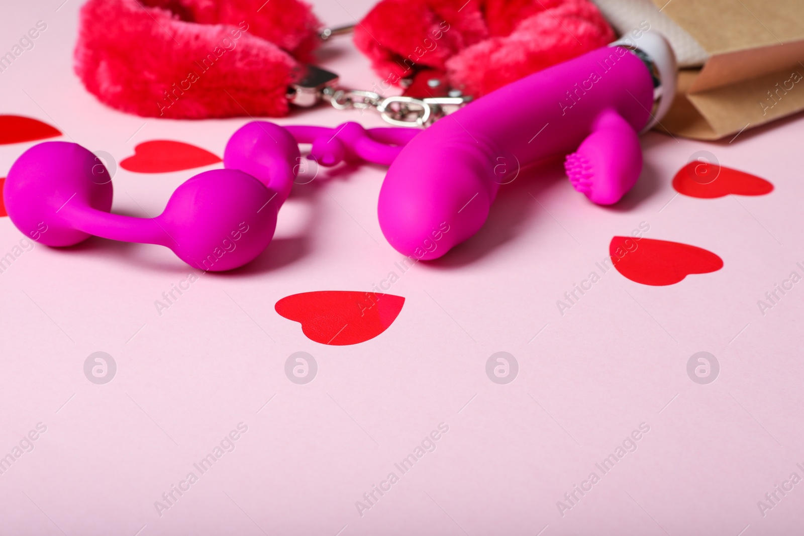 Photo of Set of different sex toys on pink background