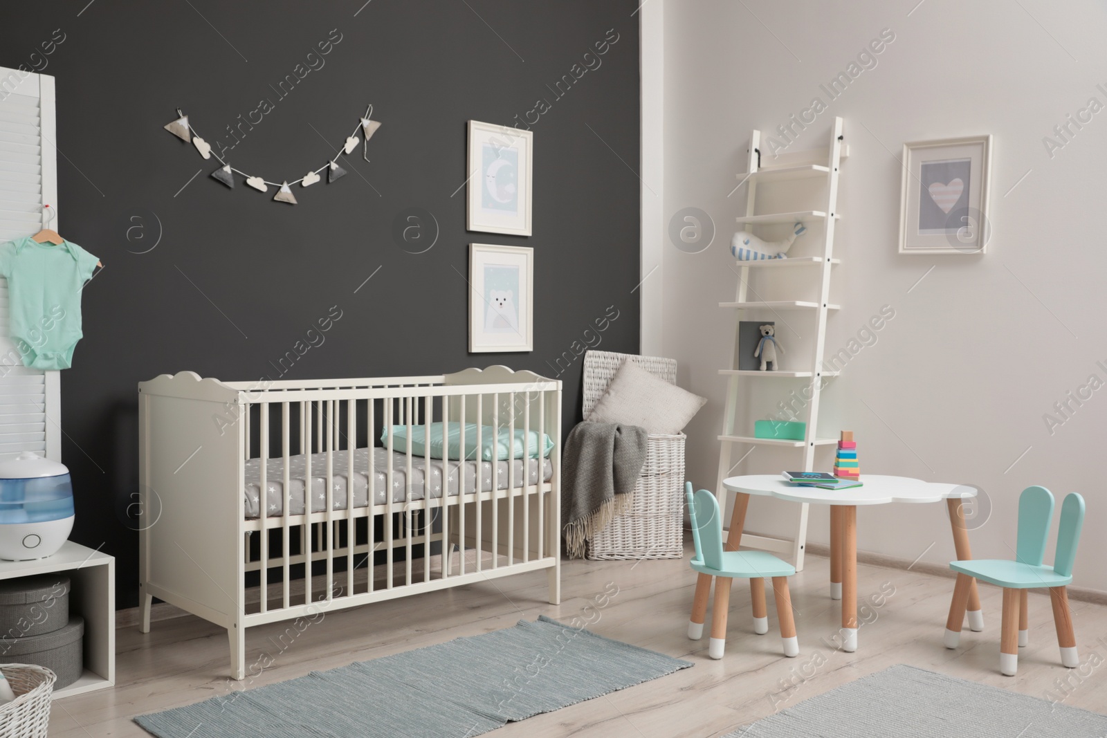 Photo of Cute baby room interior with modern crib near dark wall