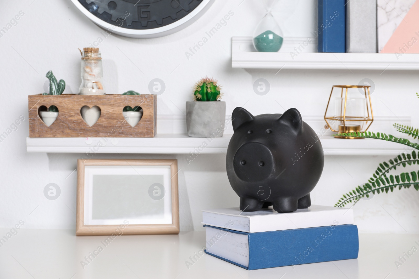 Photo of Color piggy bank on table in room. Cute interior element