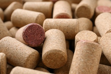 Photo of Many corks of wine bottles as background, closeup
