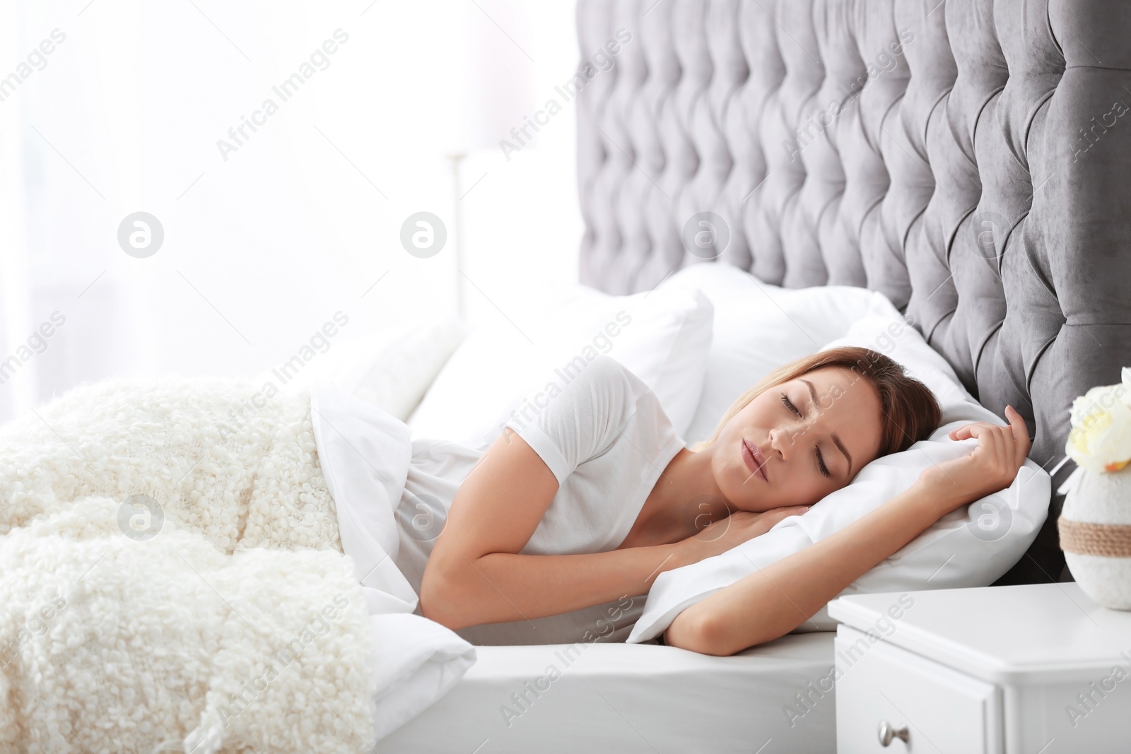 Photo of Young beautiful woman sleeping in bed at home. Early morning