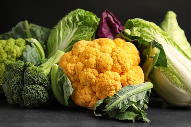 Different fresh cabbages on table. Healthy food