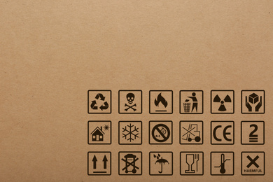 Image of Cardboard box with packaging symbols as background, closeup