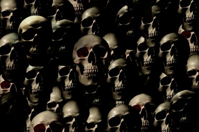 Many scary human skulls as background. Collage design