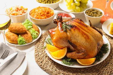 Delicious roasted turkey with garnish on dinner table