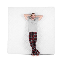 Young man with comfortable mattress isolated on white