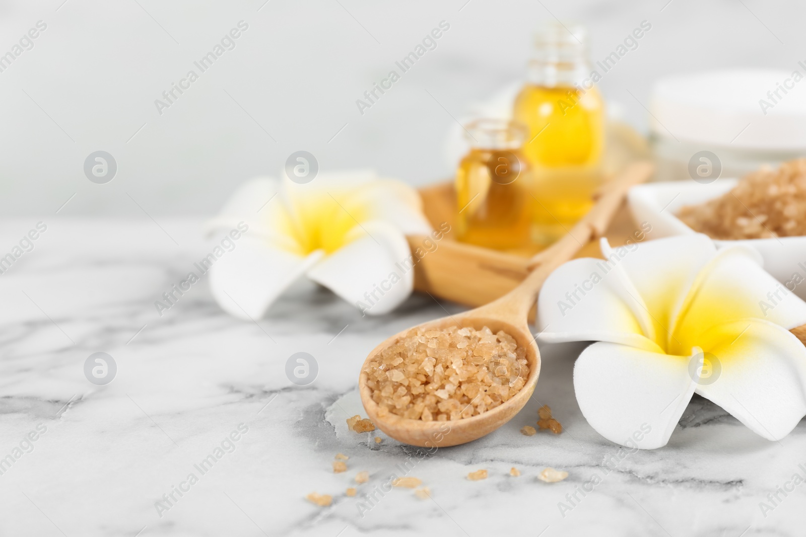 Photo of Beautiful spa composition with sea salt and aroma oil on white marble table, closeup