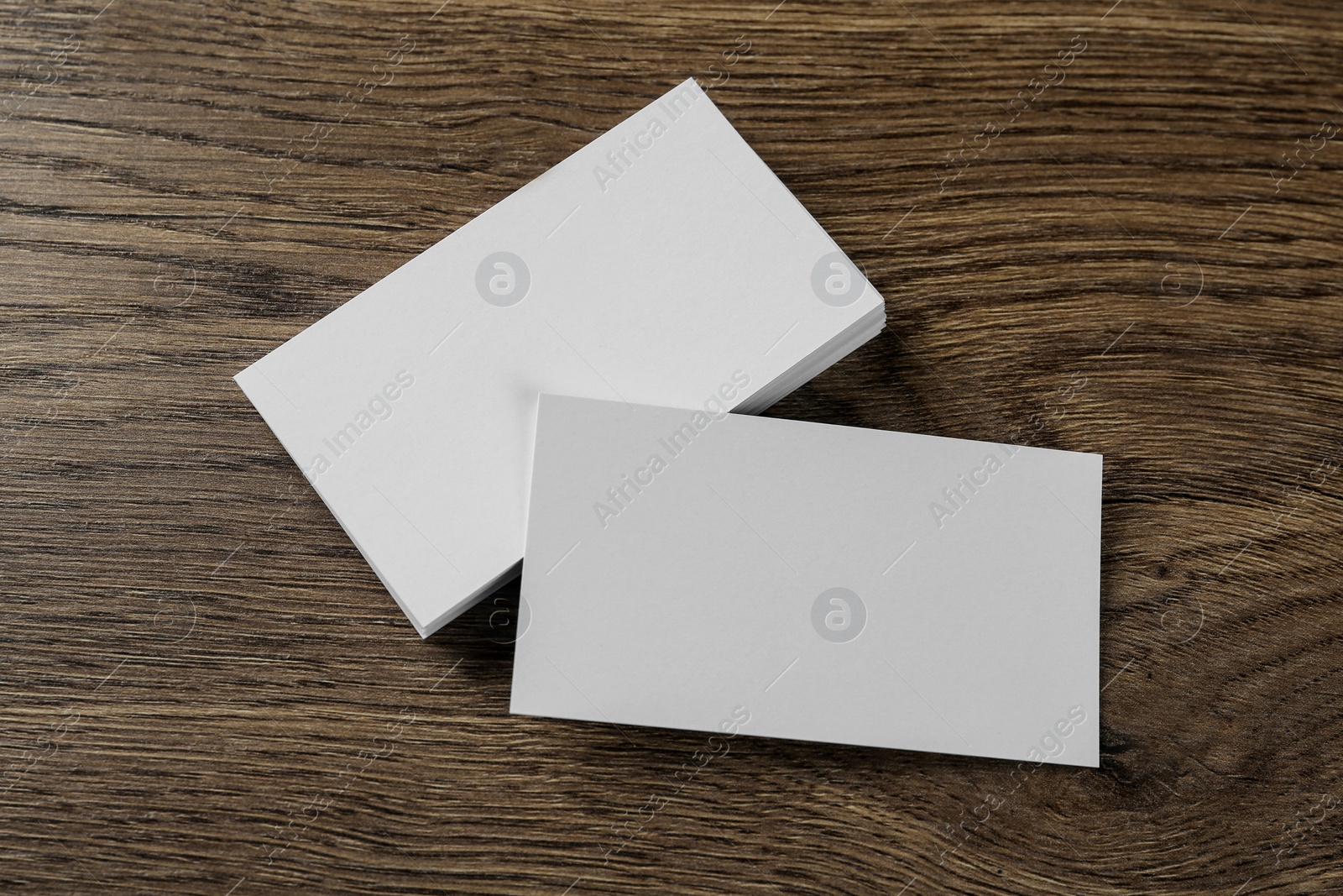 Photo of Blank business cards on wooden background, flat lay. Mockup for design