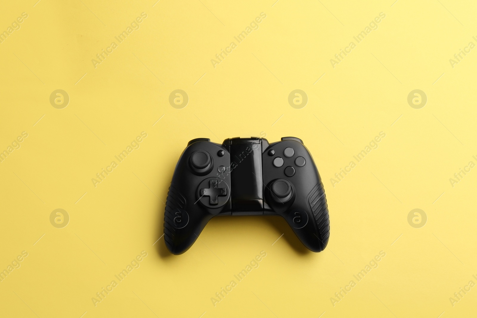 Photo of Modern video game controller on color background, top view