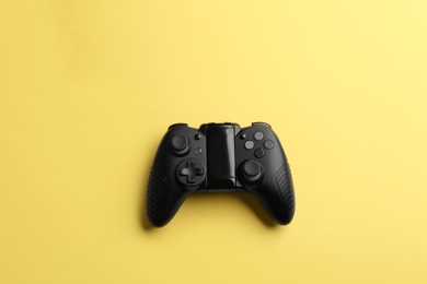 Photo of Modern video game controller on color background, top view