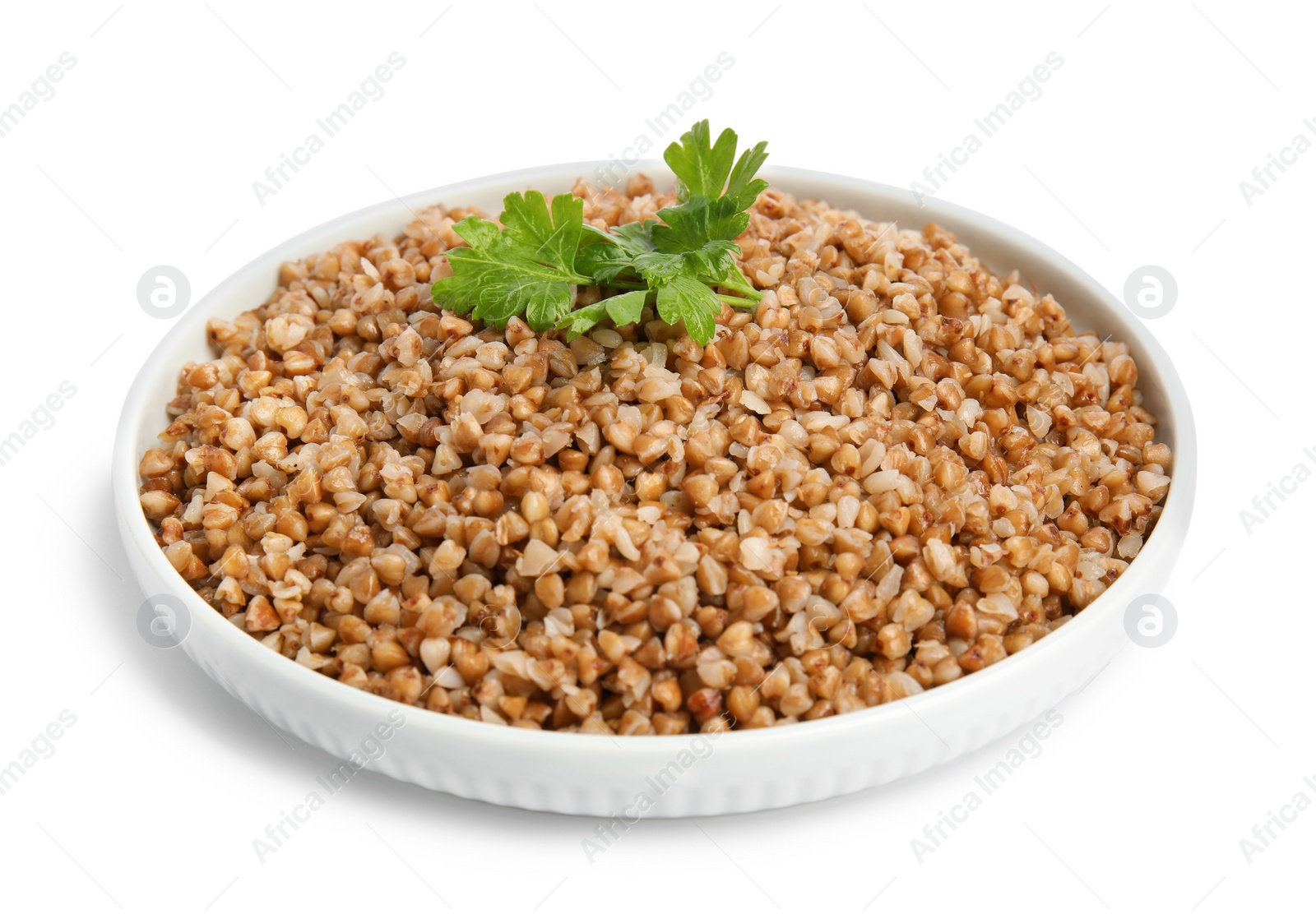 Photo of Plate of buckwheat porridge with parsley isolated on white