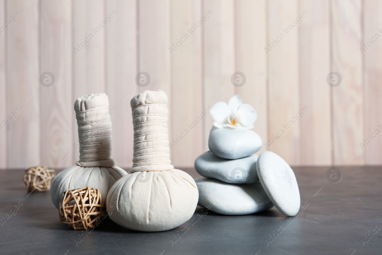 Photo of Beautiful composition with spa stones and compress stamps on table