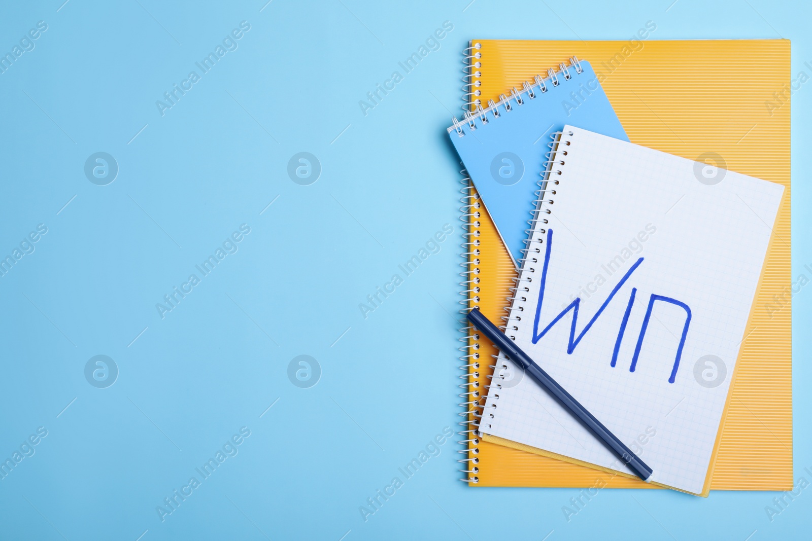 Photo of Flat lay composition of notebooks with word Win and space for text on color background. Victory concept