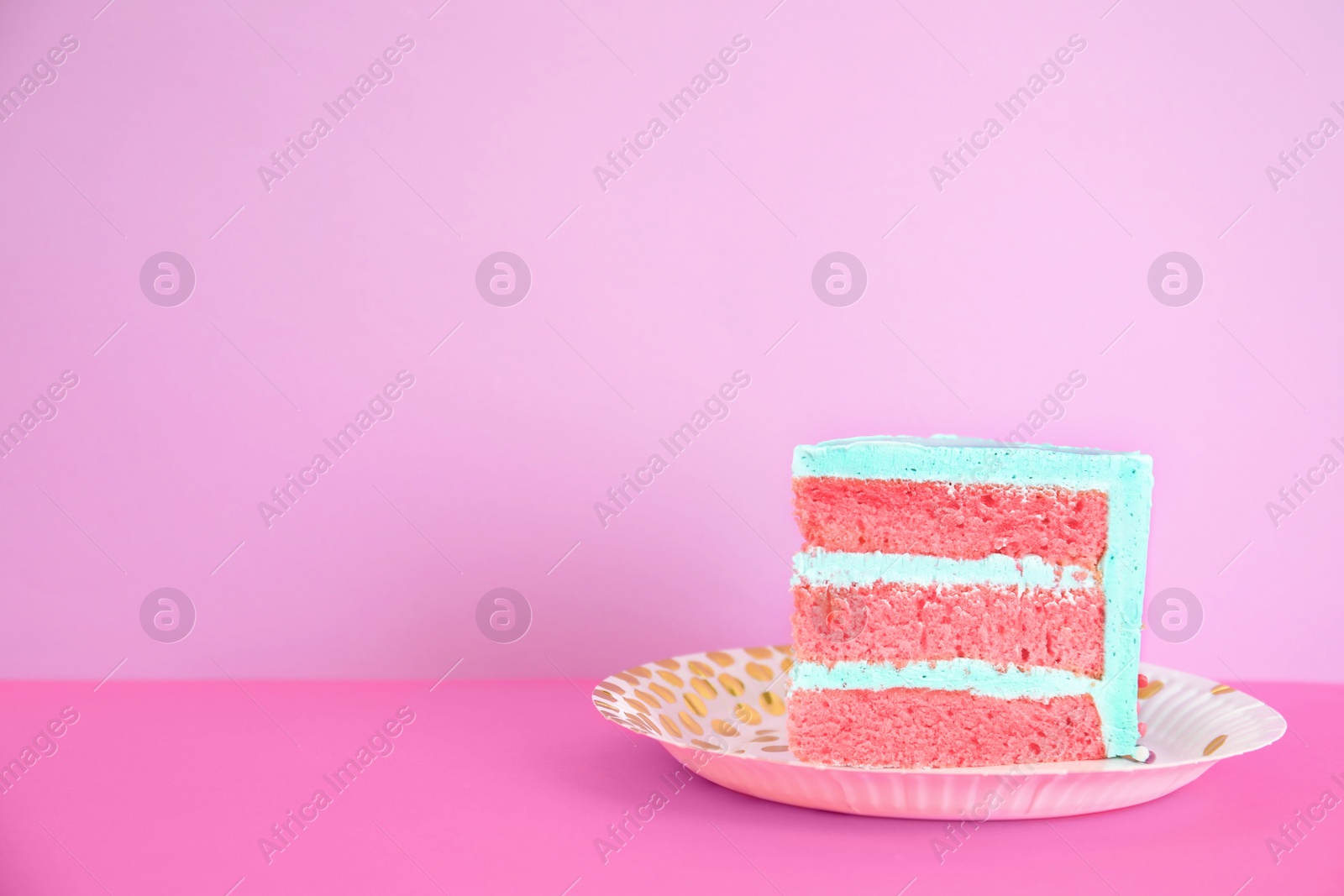 Photo of Slice of fresh delicious birthday cake on table against color background. Space for text