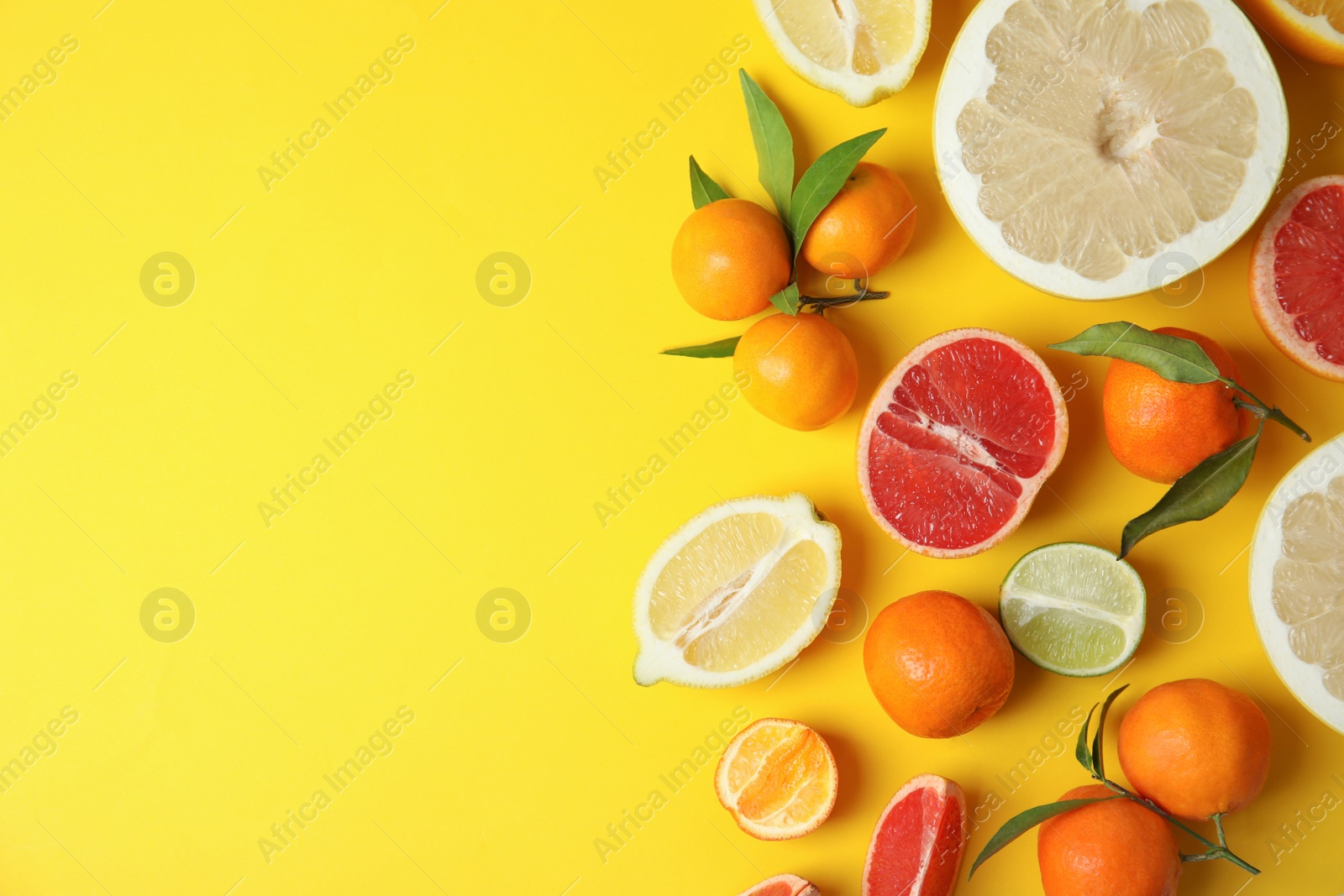 Photo of Different citrus fruits on color background, top view. Space for text