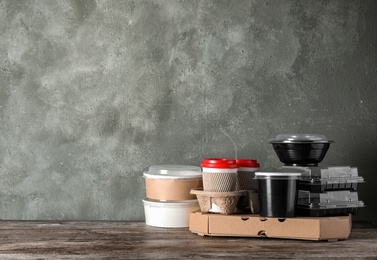 Various takeout containers on table, space for text. Food delivery service