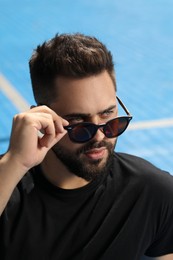 Photo of Handsome man in sunglasses outdoors on sunny day