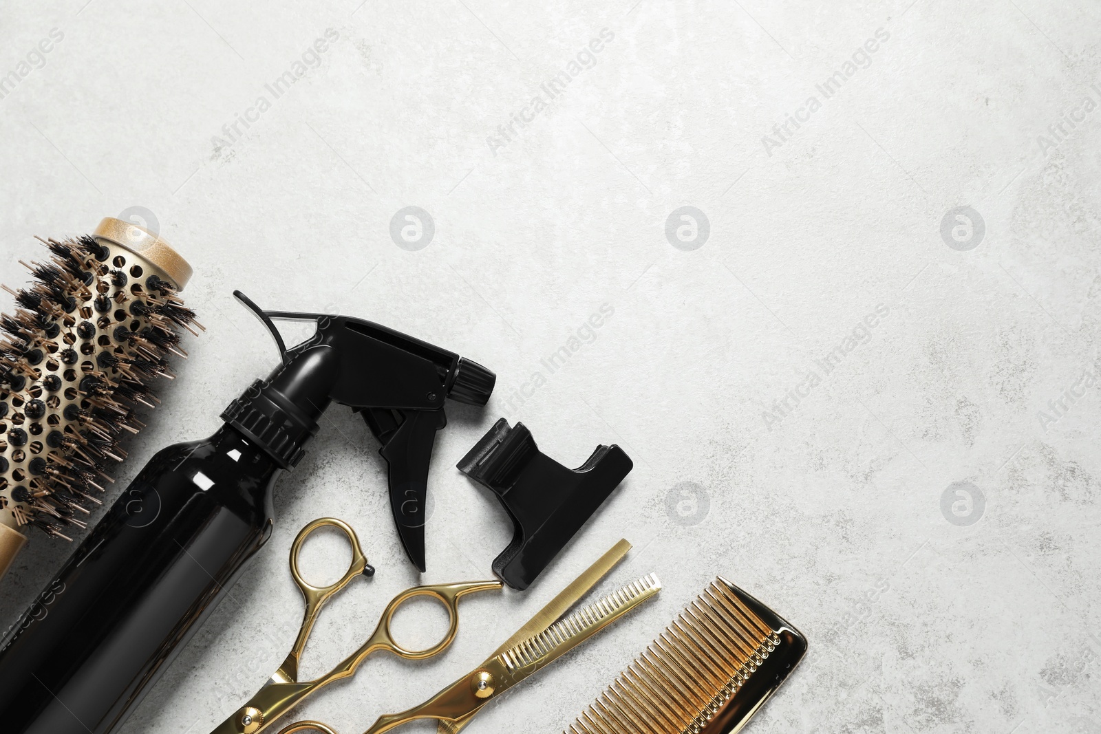 Photo of Professional hair dresser tools on grey textured background, flat lay. Space for text