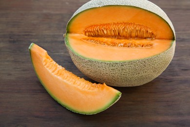 Cut delicious ripe melon on wooden table