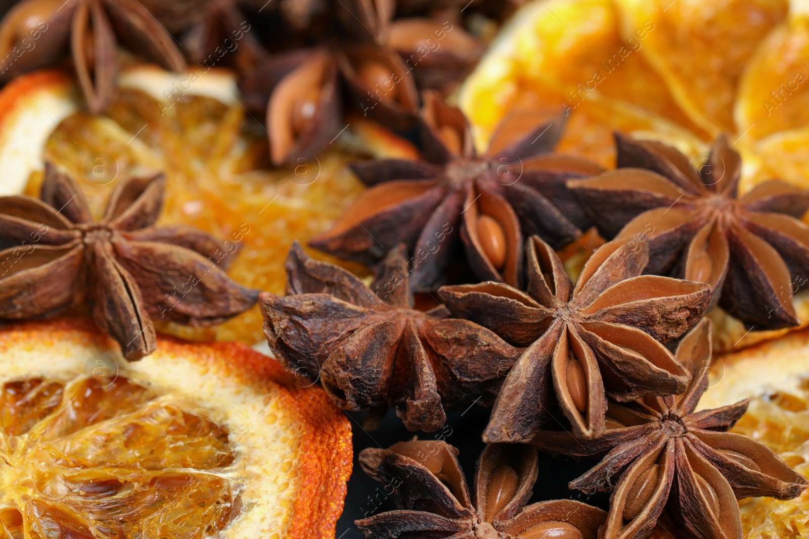 Photo of Dry orange slices and anise stars as background, closeup