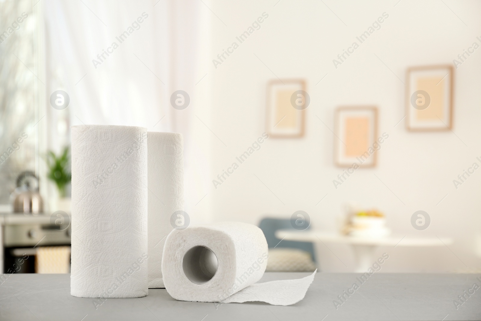 Photo of Rolls of paper towels on table in kitchen