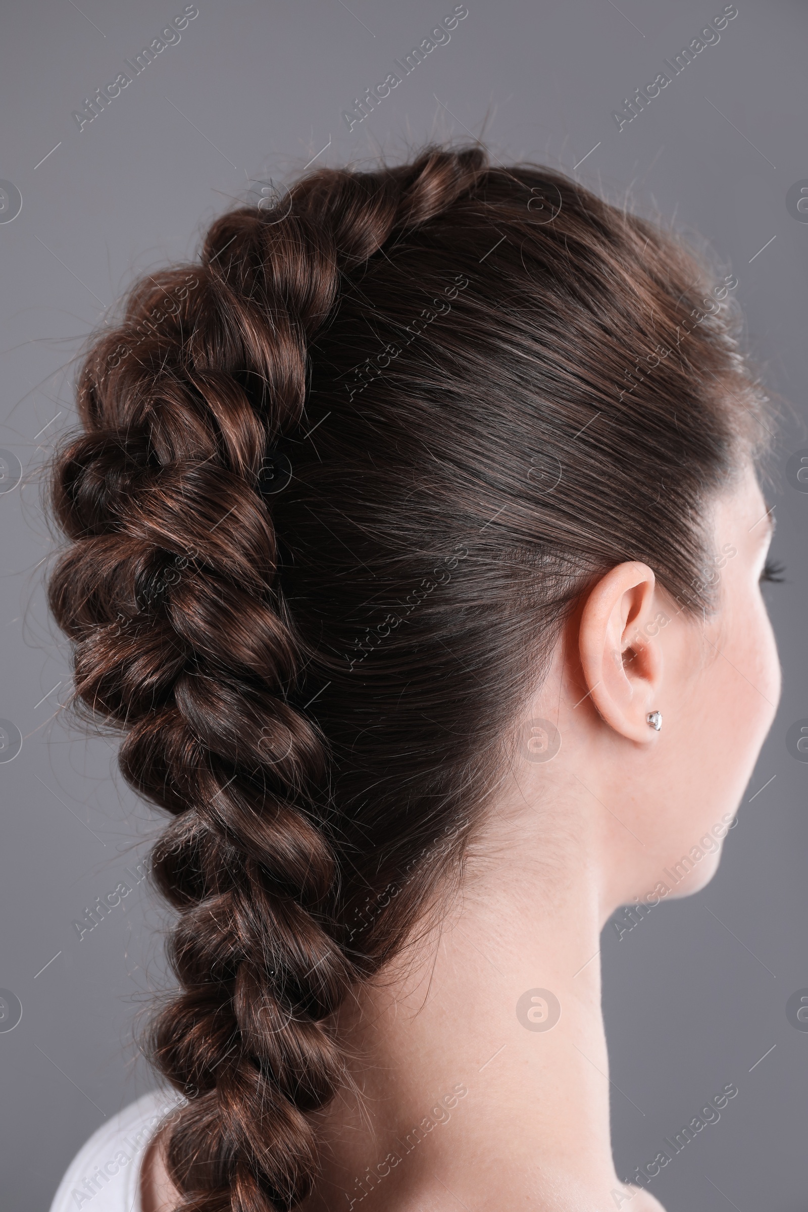 Photo of Woman with braided hair on grey background