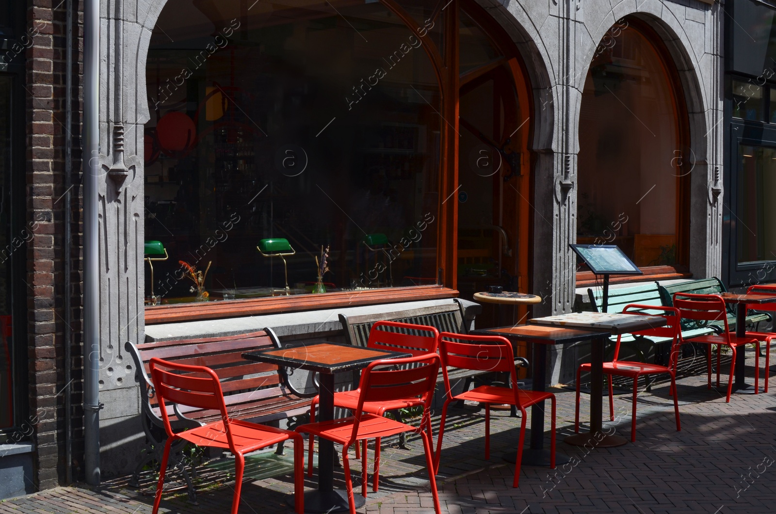 Photo of Beautiful view of outdoor cafe with stylish furniture on sunny day