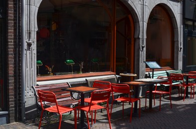 Photo of Beautiful view of outdoor cafe with stylish furniture on sunny day