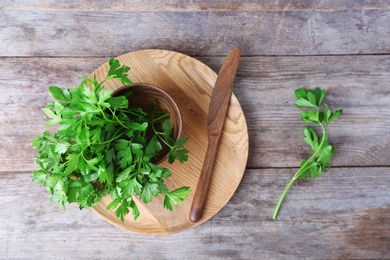 Photo of Flat lay composition with fresh green parsley on wooden background