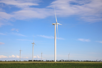 Beautiful view of field with wind turbines. Alternative energy source