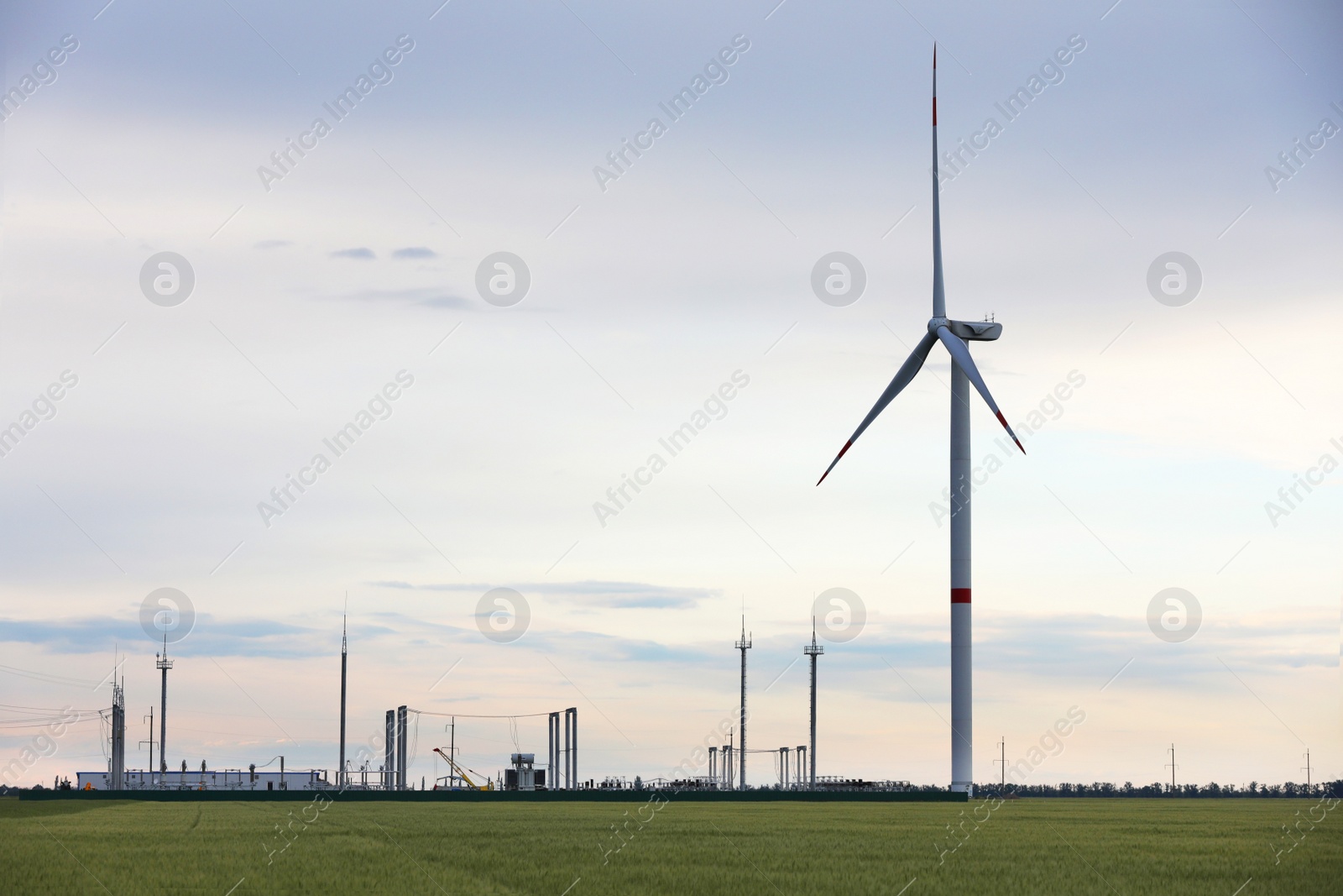Photo of Beautiful view of landscape with wind turbine in evening. Alternative energy source
