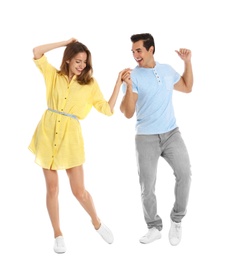 Beautiful young couple dancing on white background