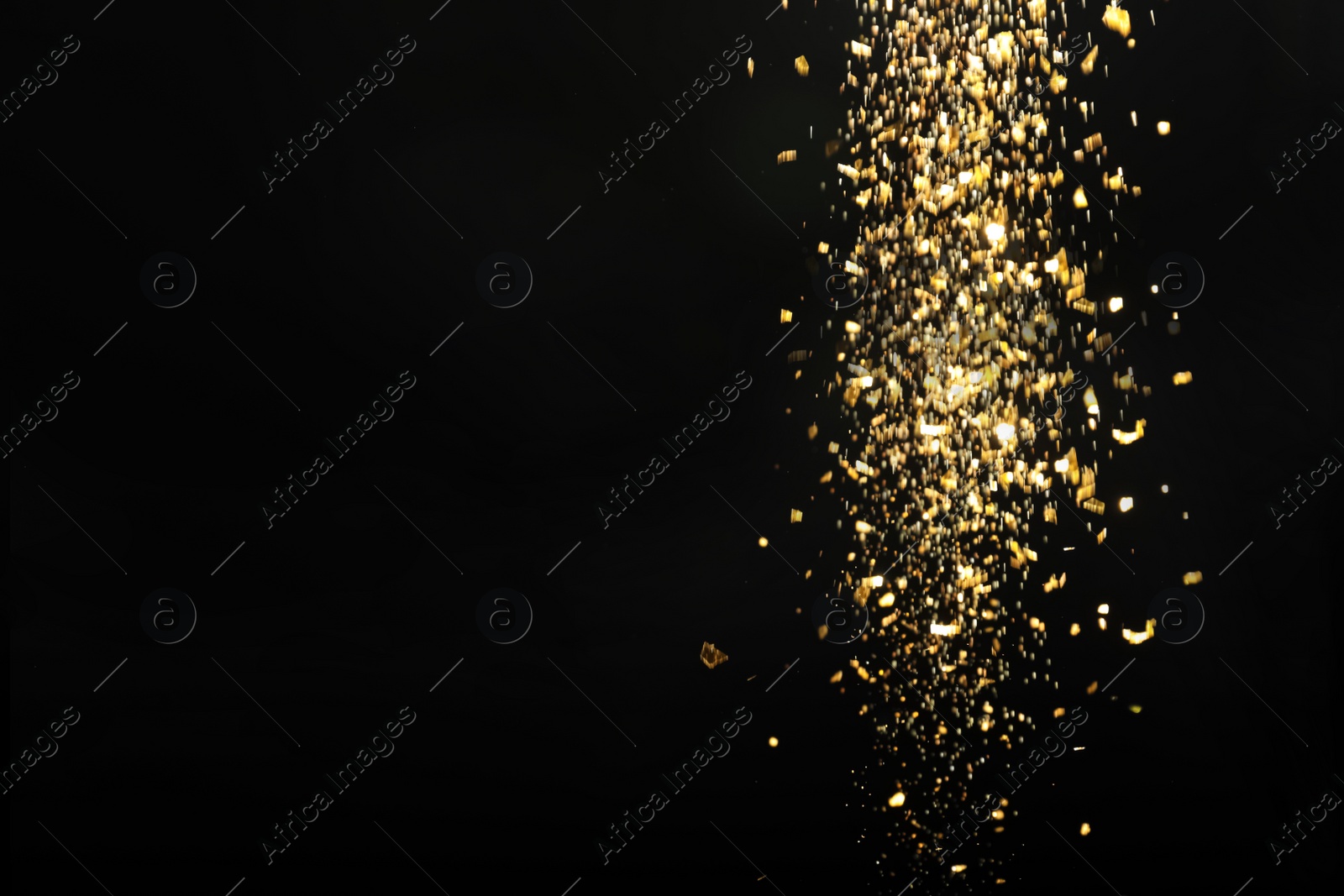 Photo of Shiny golden glitter falling down on black background, space for text. Bokeh effect