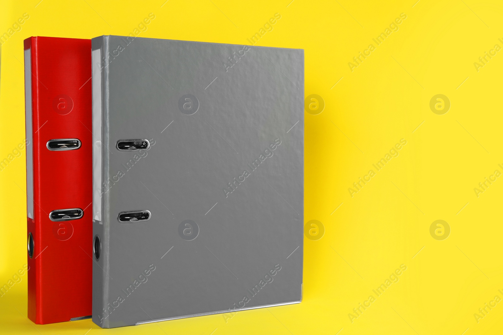 Photo of Hardcover office folders on yellow background, space for text