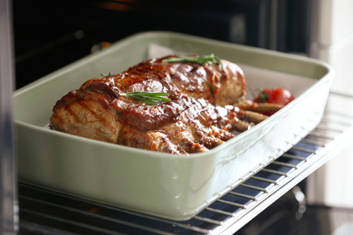 Delicious roasted ribs with tomatoes in oven