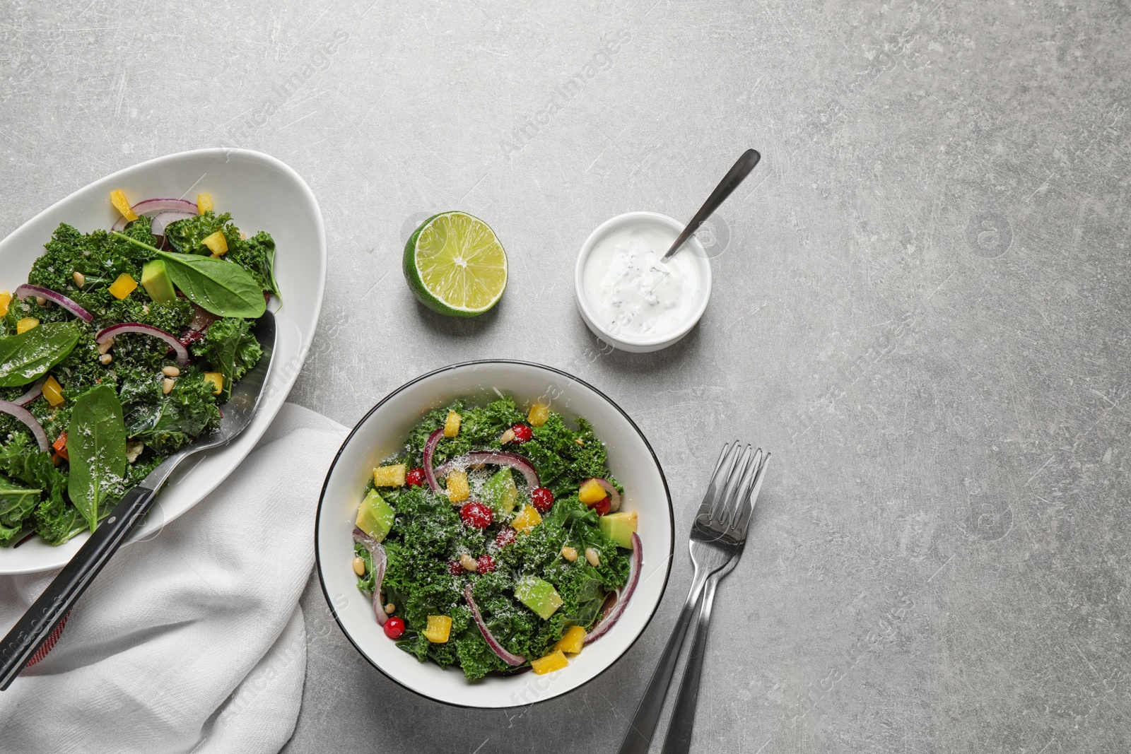 Photo of Tasty fresh kale salad on light grey table, flat lay